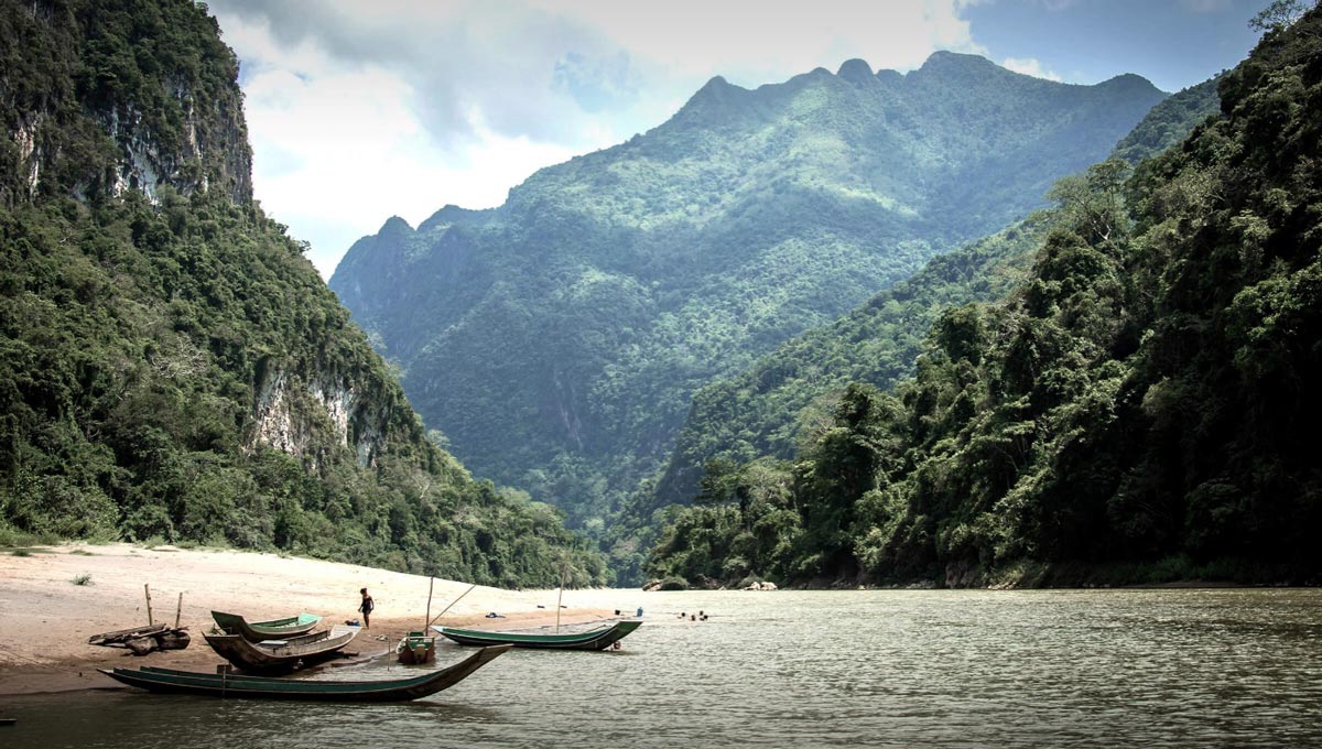 Two boats on the Namkhan River in Laos, a mountainous area known for its rich culture.