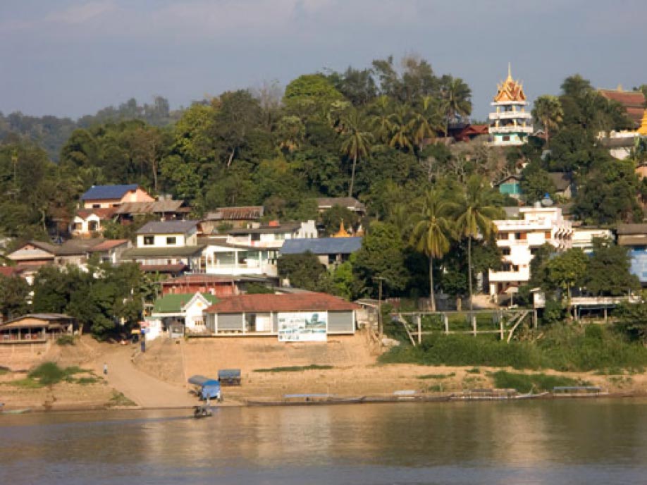 A scenic view of the Huay Xai river in Bokeo Province, Laos, dotted with charming houses along its banks.