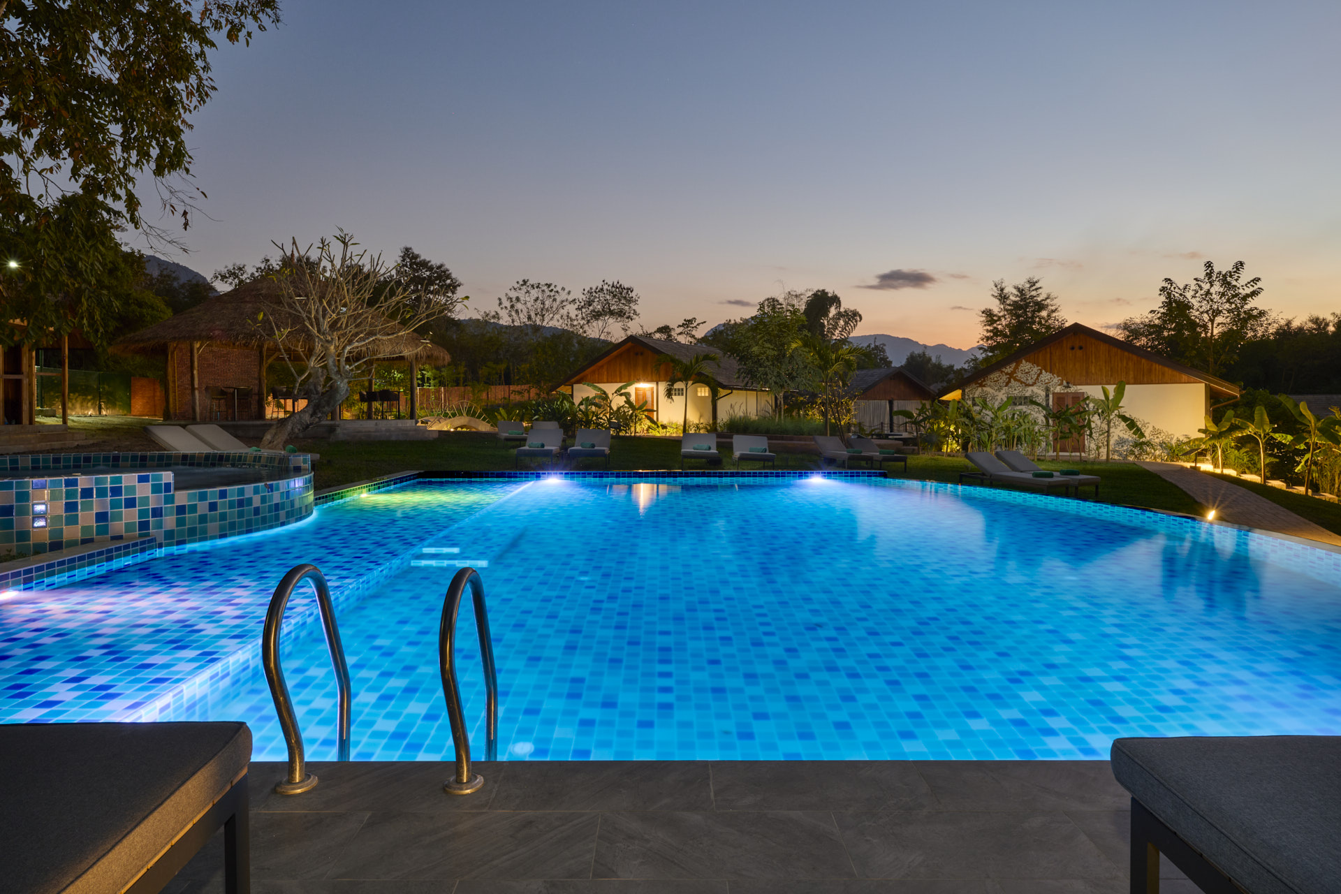The pool in Luang Prabang is lit up at dusk.