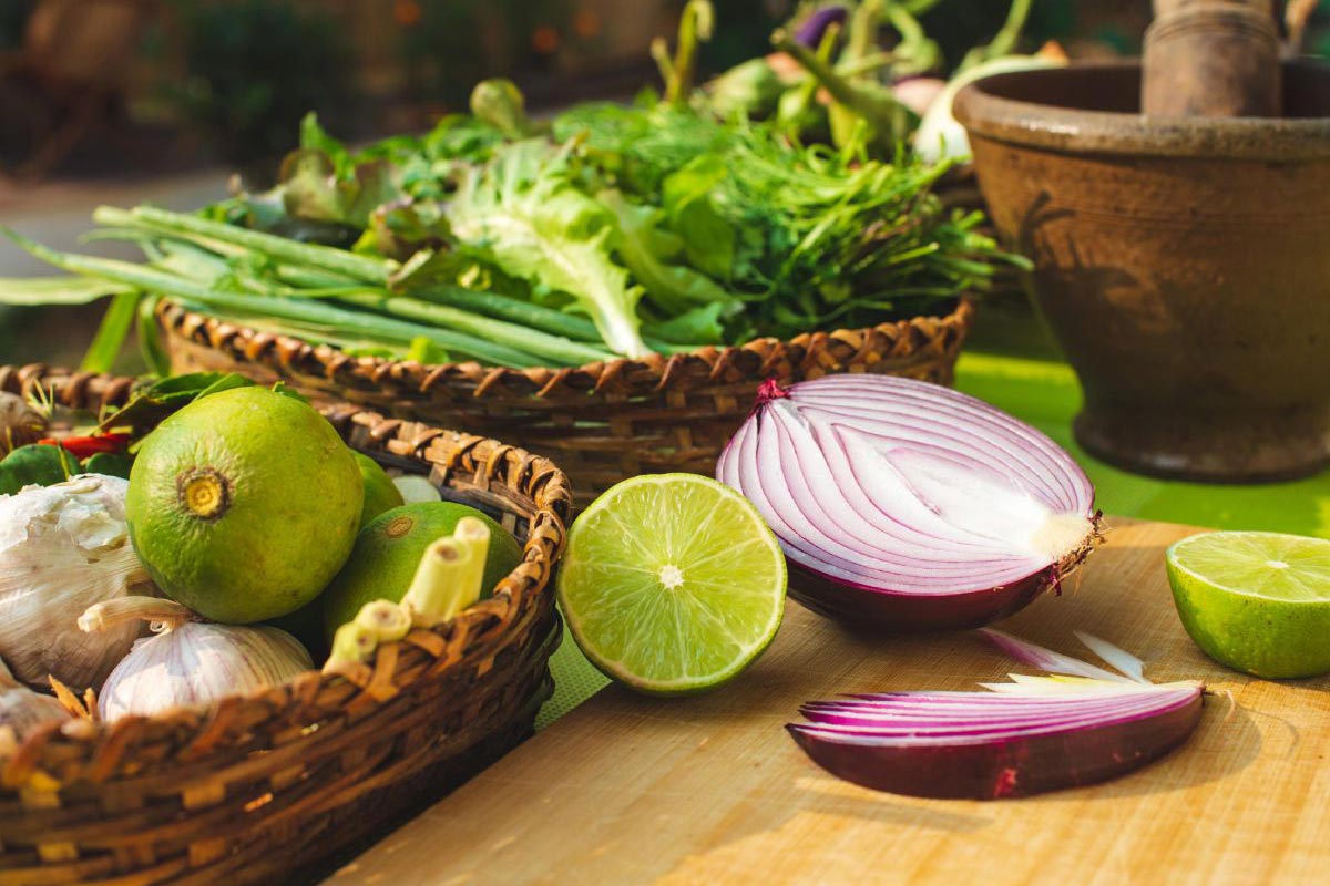 In this cooking class, learn to create authentic Thai dishes using fresh Thai herbs and vegetables. Discover the secret to unlocking their flavors as you prepare them on a table adorned with a mortar and pestle.
