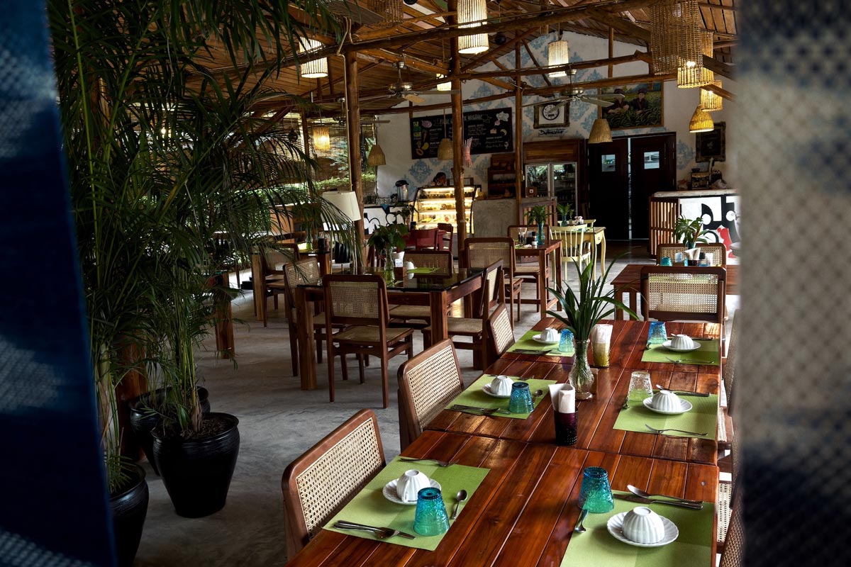 A farm-to-table restaurant with wooden tables and chairs.