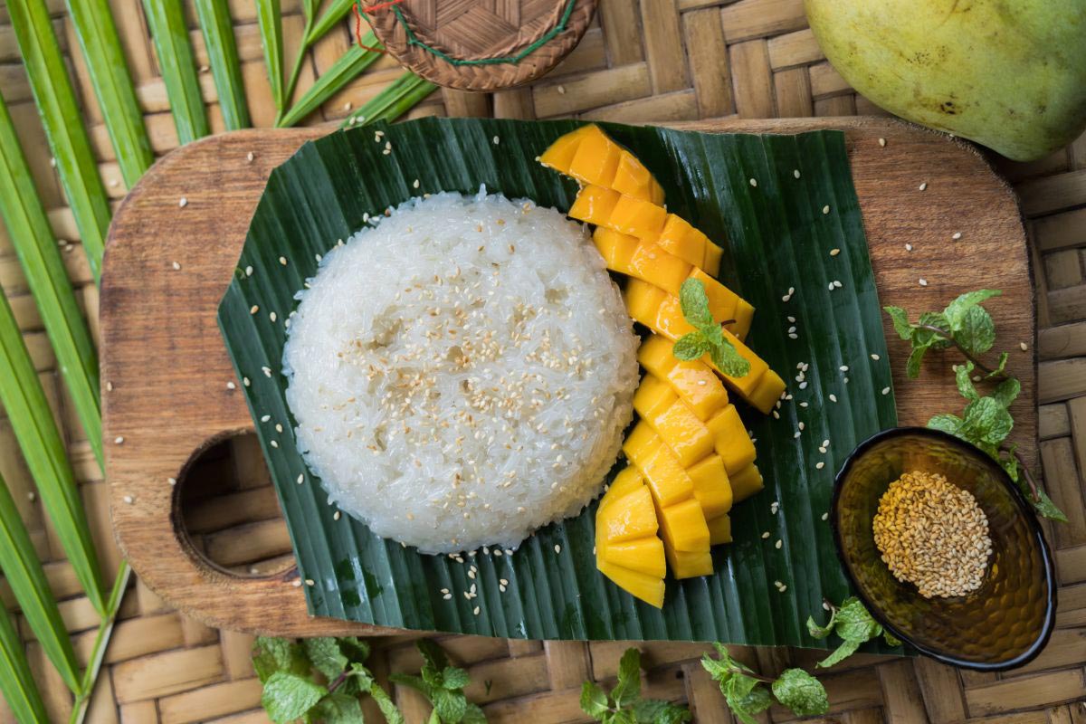 Farm to table: Rice and mango on a wooden cutting board, sourced directly from the farm.