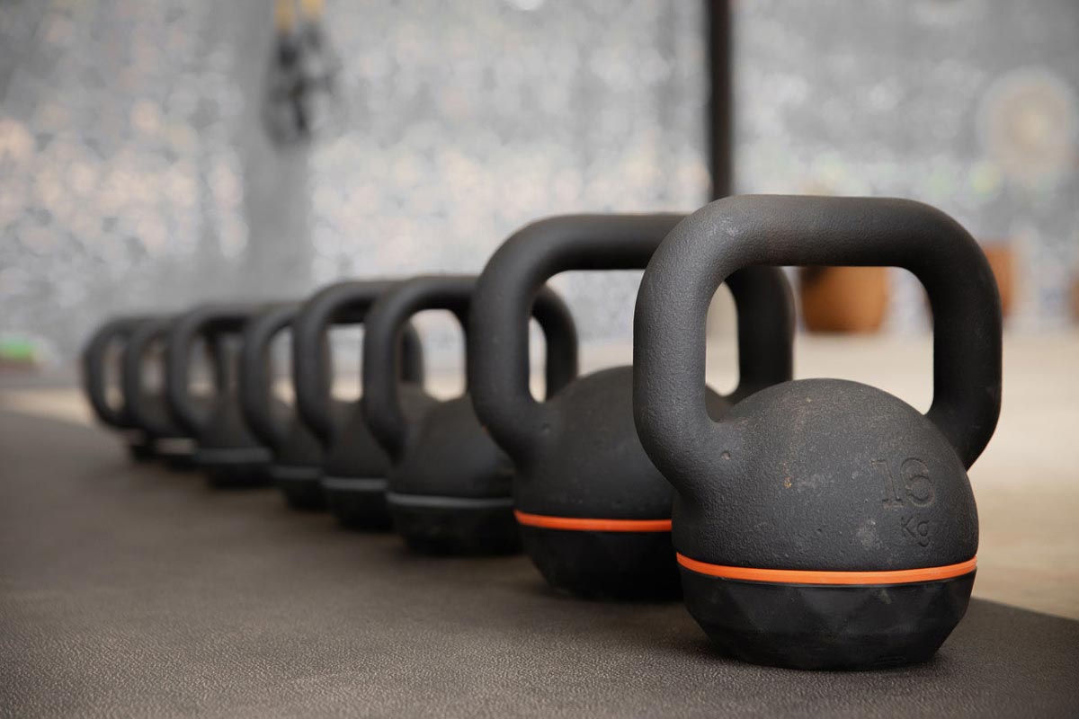 A row of fitness kettlebells in a gym.