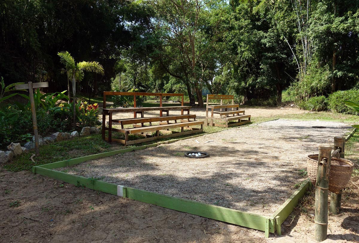 A bocce court nestled in a serene wooded area.