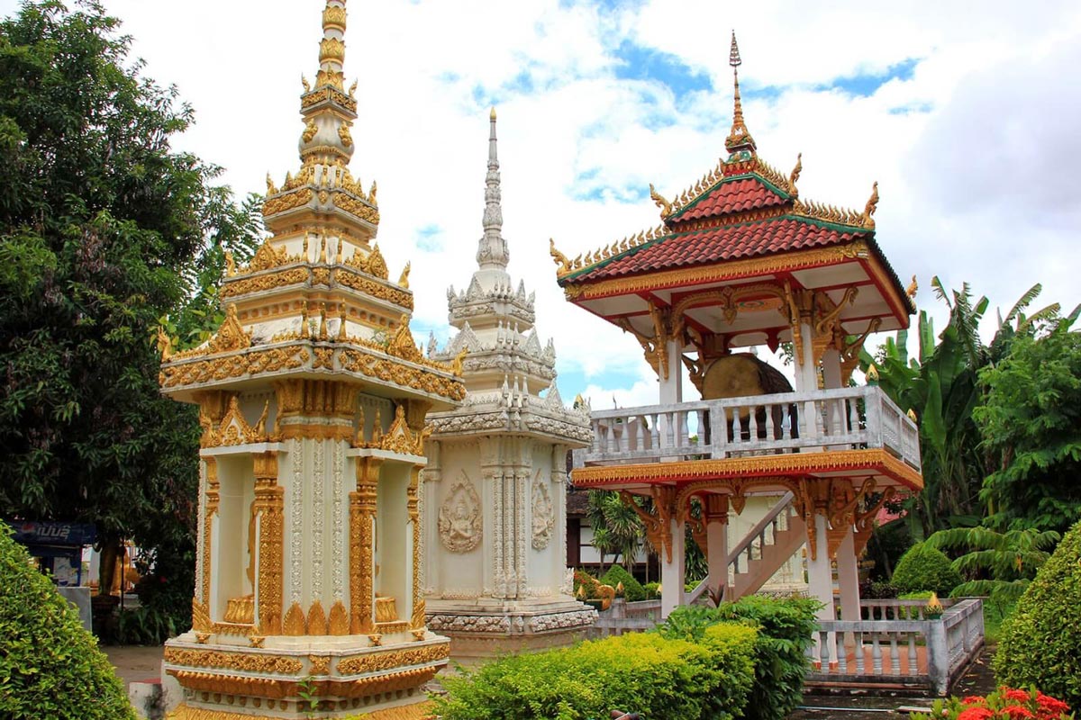 Wat Si Saket, a white and gold pagoda in the middle of a garden, graces the vibrant landscapes of Laos.