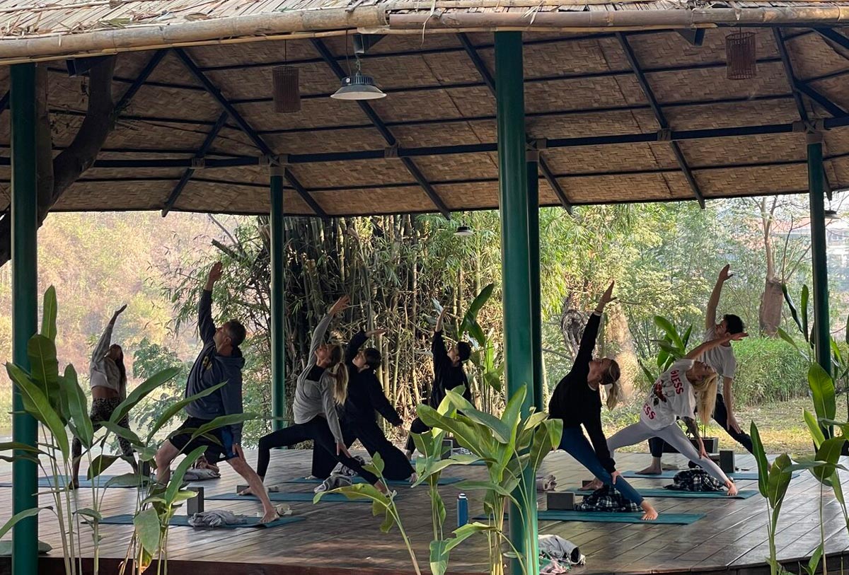 A yoga group practicing in a gazebo.