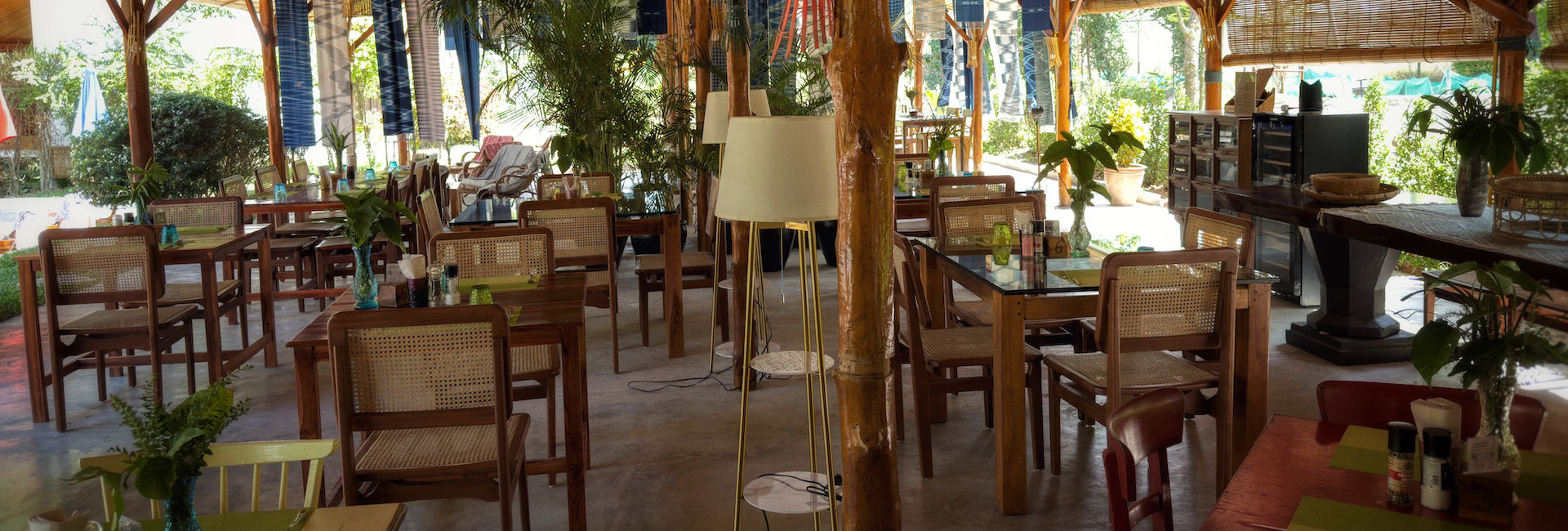 In the charming city of Luang Prabang, a cozy restaurant invites diners to relax at their well-appointed table and chairs.