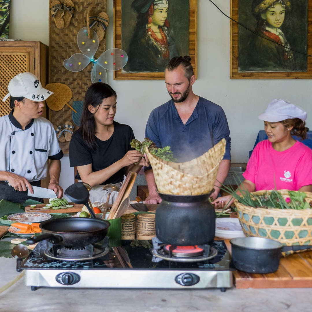 A group of people preparing food in a Luang Prabang kitchen.