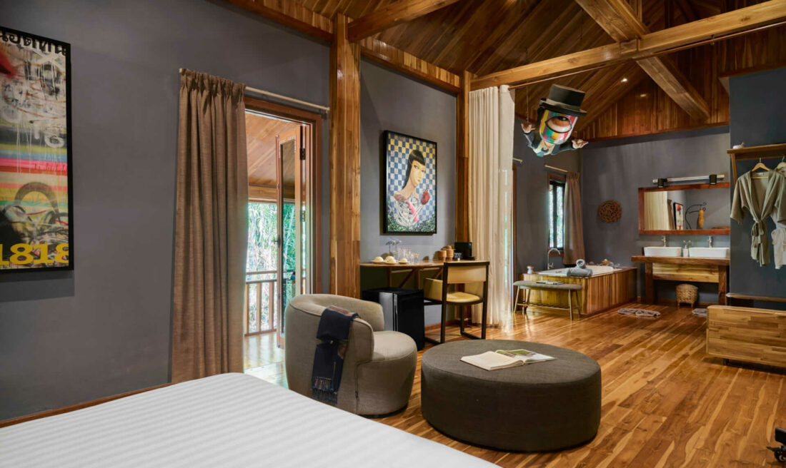 A luang prabang-inspired bedroom with wooden ceilings and wooden floors.