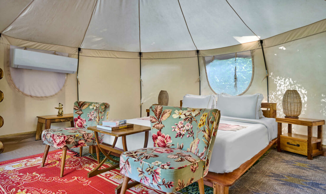 A tepee tent with a bed and chairs in Luang Prabang.