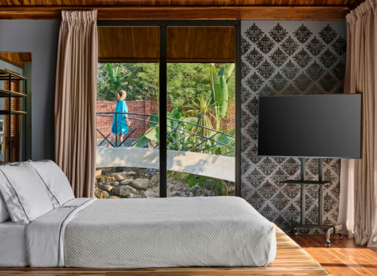 A bedroom in Luang Prabang with a large bed and a view of the ocean.