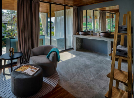 A room in Luang Prabang with a wooden floor and a view of the ocean.
