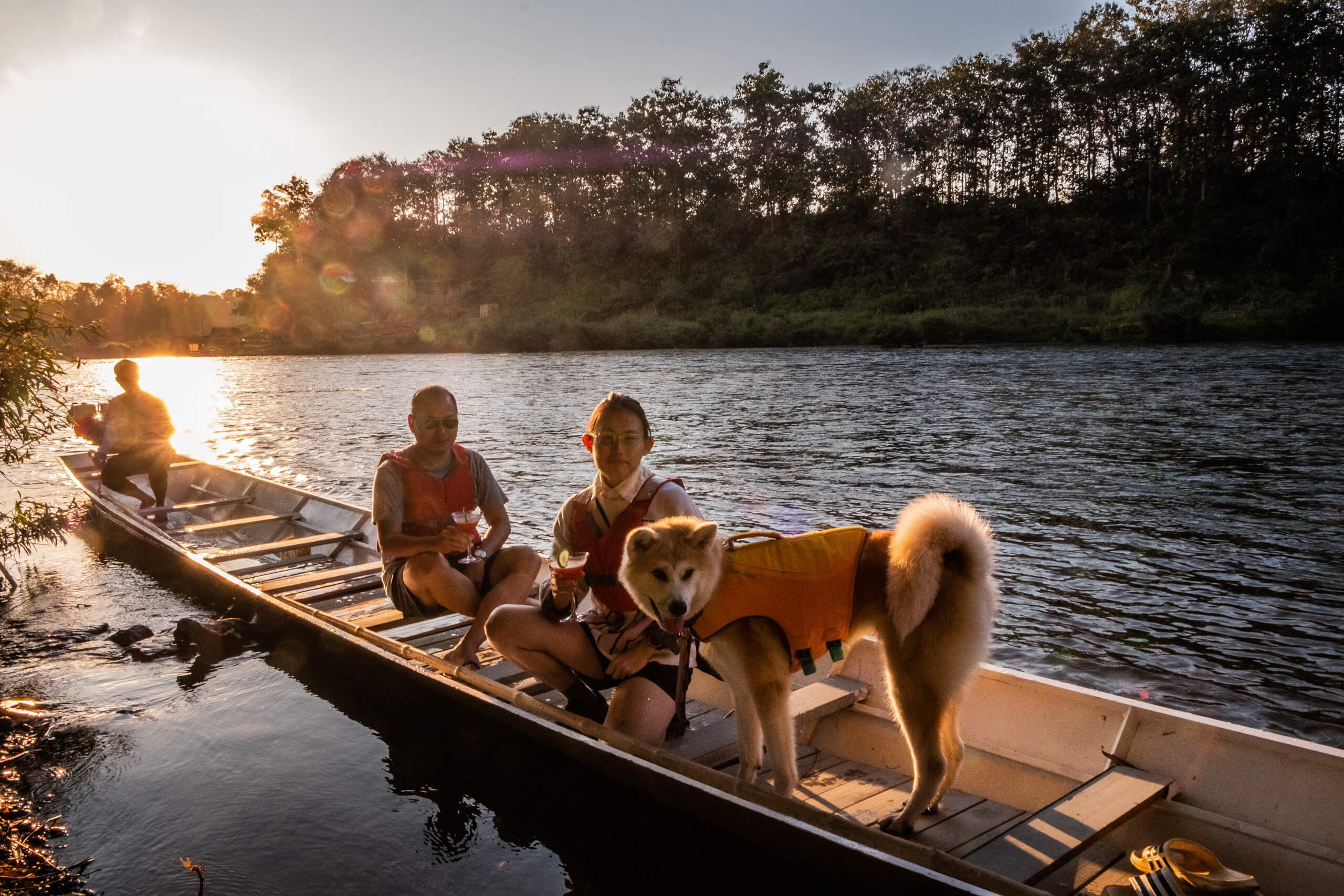 The Namkhan's sunset boat tour with 3 men and a dog in life vests