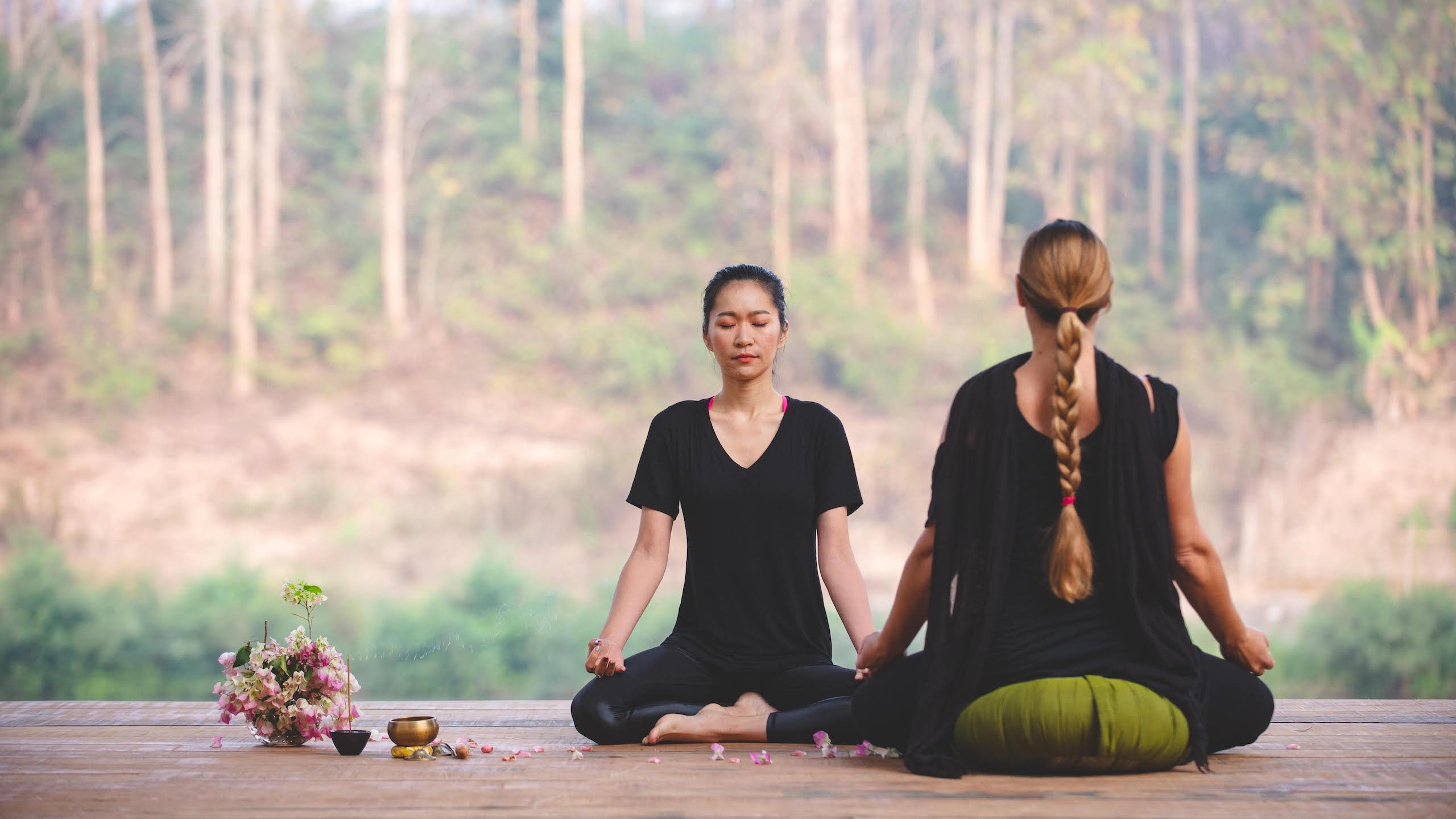 Two women meditating at The Namkhan Resort In Laos in Luang Prabang