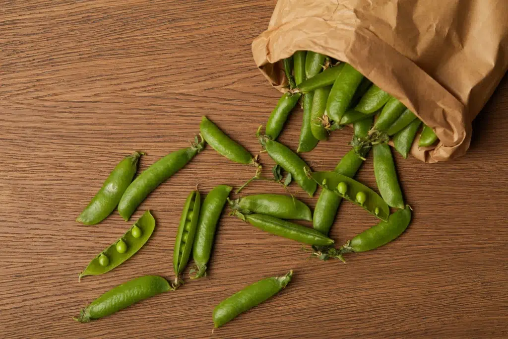 top view of pea pods spilled from paper bag on woo 2023 11 27 05 32 49 utc scaled scaled