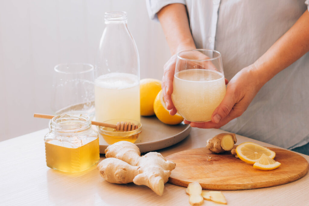 women s hands hold glass with drink made from ging 2023 11 27 05 09 33 utc scaled