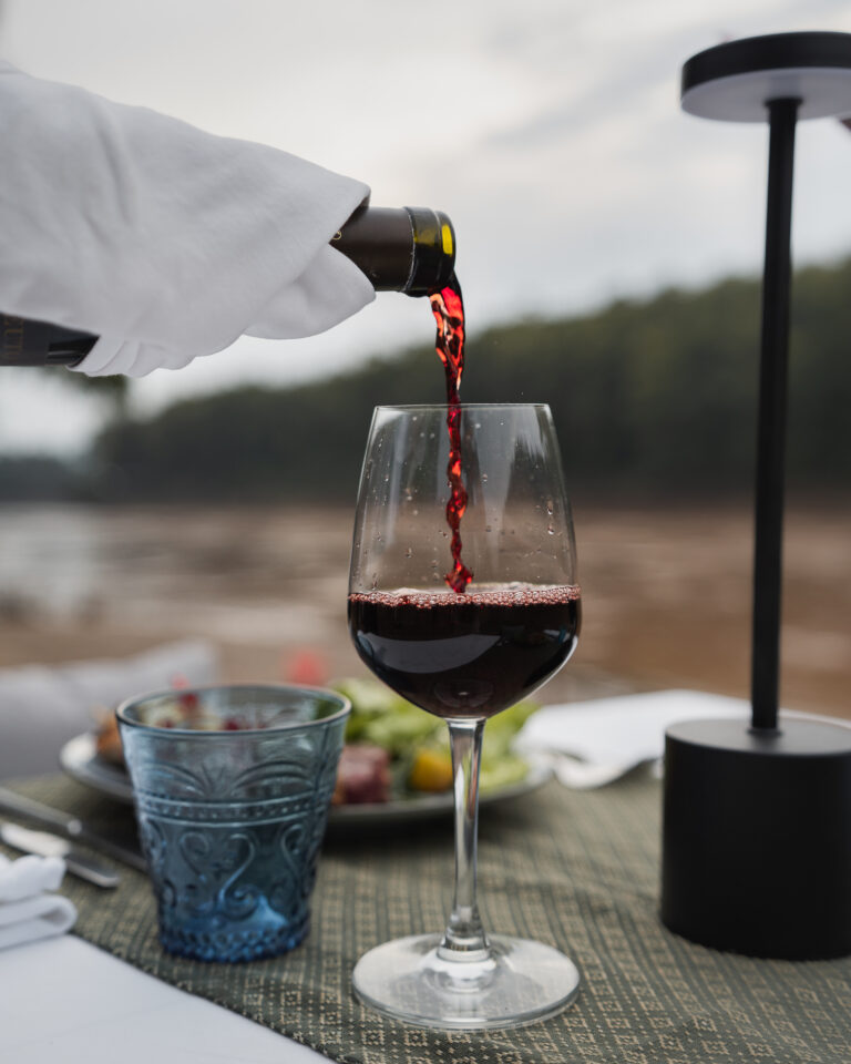 Glass of wine by the Nam Khan River